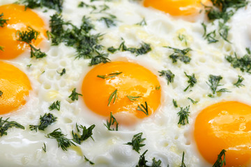 Close-up photo of scrambled eggs in black frying pan