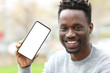 © PheelingsMedia - Happy black man showing phone with blank screen