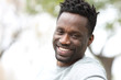© PheelingsMedia - Happy black man with perfect smile looking at camera
