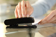 © PheelingsMedia - Girl hands using stapler on documents over a desk at home