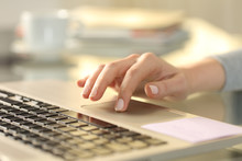 Woman Hand With Laptop Using Touchpad On A Desk