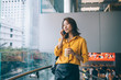 © BullRun - Beautiful Asian woman calling by smartphone in room