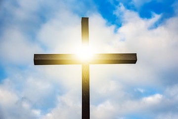 wooden cross against sky background , easter background. christian cross against celestial clouds.