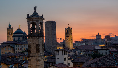 Wall Mural - Bergamo at sunset in the old city with towers and bell tower,