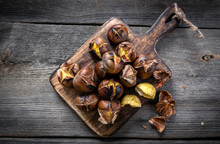 Roasted Chestnuts On Wooden Background