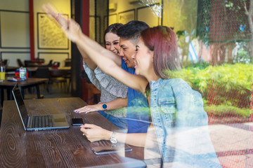 Wall Mural - Attractive young people joining hands in cafe