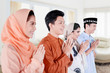 © Creativa Images - Muslim people showing a greeting hands at home