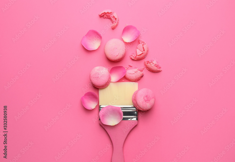 Paint brush with with macarons on color background