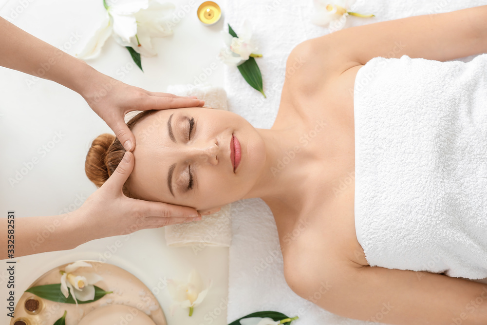 Beautiful woman receiving massage in spa salon