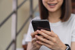© sompong - woman holding and using smartphone typing sms message at social network.