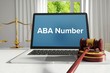 ABA Number – Law, Judgment, Web. Laptop in the office with term on the screen. Hammer, Libra, Lawyer.