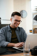 © JustLife - Designer in office. Businessman working on new architect project.