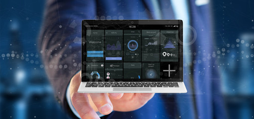 Poster - Businessman holding Laptop with business user interface data on the screen isolated on a background