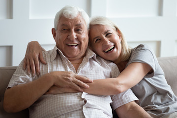 Wall Mural - happy older wife and husband hugging and laughing together, having fun, smiling mature father and ad
