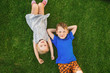 © Igor - children lying on the green grass in the Park. The interaction of the children