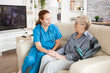 © DC Studio - Old woman sitting on a couch in a nursing home telling a story