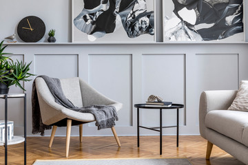 modern scandinavian home interior of living room with design gray sofa, armchair, marble stool, blac