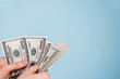 © Leart - money in a hand over blue background