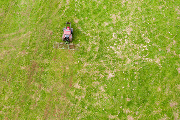 Sticker - a farming machine from above on a green meadow