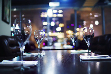 nightclub penthouse in a skyscraper / table setting with glasses and night lights, party, alcohol, the interior of a night club