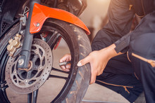Motorcycle Repair Service, Mechanic Is Pumping The Tire, Close-up.