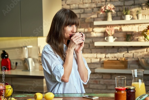 Happy woman at home drinking coffee at morning Tableau sur Toile