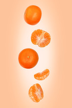 Falling Mandarins Isolated On An Orange Background With Clipping Path As Package Design Element And Advertising