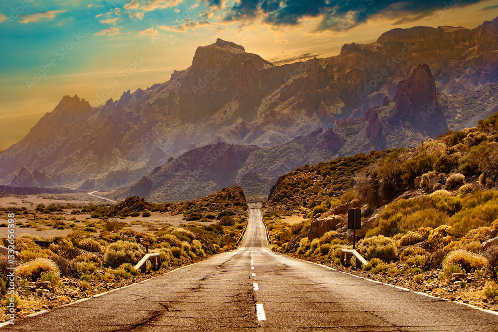 Image related to unexplored road journeys and adventures.Road through the scenic landscape to the destination in Tenerife natural park. - obrazy, fototapety, plakaty 