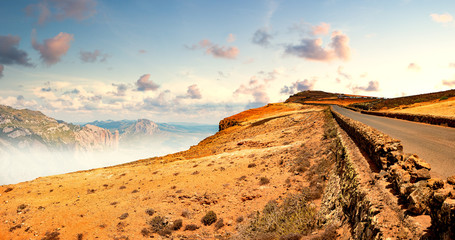 Wall Mural - country road background and colorful sunset landscape.car travelling and scenic desert road.adventur