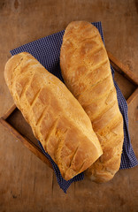 Homemade bread on a wooden table. Bread loaf and baguette. Simple homemade food. Yeast dough.