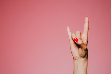 woman's hands with bright manicure isolated on pink background hevy metal sign