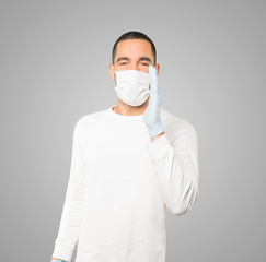 Coronavirus.Young man doing concepts and wearing mask and protective gloves