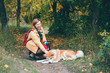 © Daniil - Young red husky dog playing with girl in park. Beautiful woman and foxy dog in autumn colors. Girl plays with white ginger husky in fresh air. Walking pet with owner in outdoors. Colorful autumn scene