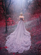 Silhouette woman queen walk in Autumn forest magic trees red leaves. Elegant blonde princess. Royal Medieval clothes vintage evening purple dress long train bare back. backdrop blue shiny mystic fog