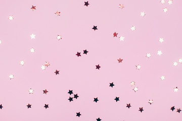 Poster - Rose gold stars on a pink background. Festive concept. Flat lay style