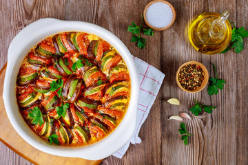 Cooked french vegaterian food ratatouille on wooden background.