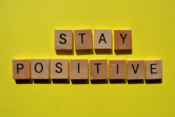 Canvas Print - Stay Positive, words in wooden alphabet letters on yellow coloured background