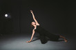 © Elizaveta - Portrait of a beautiful woman dancing on black background. Ballet and contemporary dancer dancing on dark backdrop. Contemporary Art. Plastic and flexible girl in black clothes posing on a black wall
