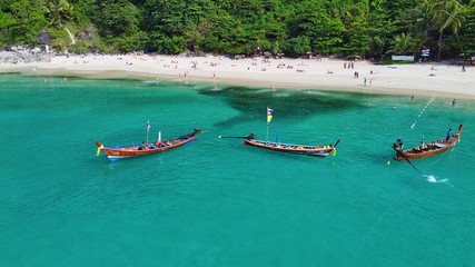 Wall Mural - Aerial view of long tail boats along a tropical beach, Thailand