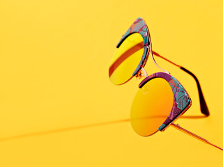 Sunglasses on orange background