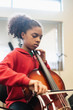 © Hill Street Studios - Teenage girl playing cello in classroom