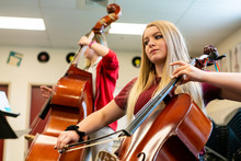 Teenage Girls Playing Cello And Double Bass In Classroom