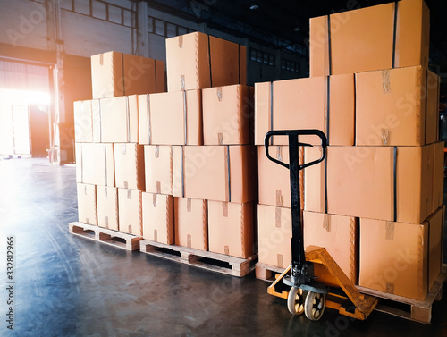 Cuadros en Lienzo Interior of warehouse storage, Stack of shipment boxes on pallets and hand pallet truck, Warehouse industry delivery shipment goods, logistics and transportation