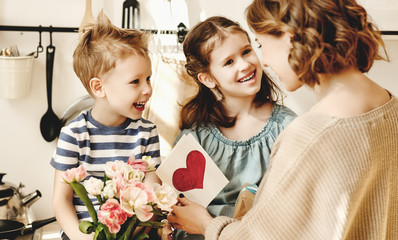 Wall Mural - Happy children giving card an flowers to mother.