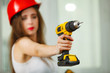 © Voyagerix - Woman using power driil for work at home
