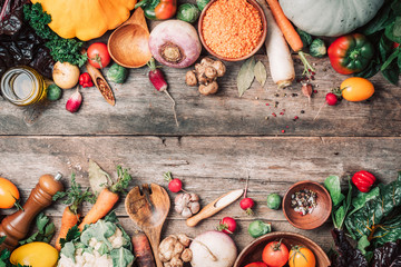 Wall Mural - Organic food. Harvest of fresh vegetables on wooden background. Top view. Copy space. Diet or vegetarian food concept. Assortment of churd, pumpkin, carrot, pepper, cabbage, garlic, tomatoes.