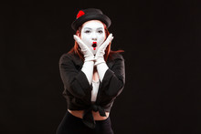 Portrait Of Female Mime Artist Performing, Isolated On Black Background. Woman Opened Her Mouth With Surprise. Symbol Of Unexpectedness, Amazement