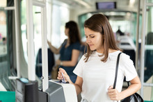 Young Woman Pays Bus Or Tram Fare