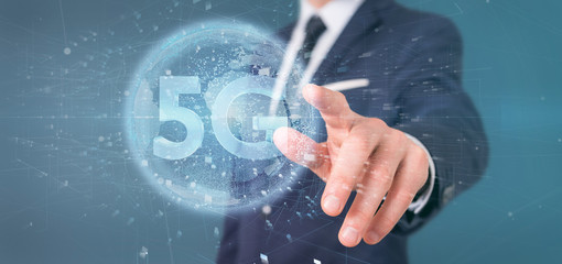 Poster - Businessman holding a 5G connection with data surrounding - 3d rendering