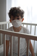 Italy , Milan - European white boy children quarantine with mask  home - contagion of the Novel Coronavirus 2019- ncov -  virus incubation isolation   